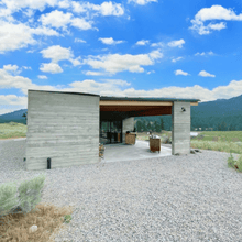 Load image into Gallery viewer, A stunning view of Garnet Valley Ranch Winery in Summerland, BC. Lush vineyards sprawl across the landscape with picturesque mountains in the backdrop. The winery's rustic charm and organic vineyards create a captivating scene for wine enthusiasts | Farm to Glass Wine Tours