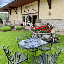 Load image into Gallery viewer, n eco-friendly picnic set up in front of the world-class Le Vieux Pin winery on the Black Sage Bench in Oliver, BC. Enjoying nature&#39;s beauty while savoring exquisite wines in a sustainable and breathtaking setting | Farm to Glass Wine Tours

